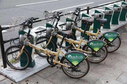 Hiroshima, Japan - April 21, 2012: City bike rental station on April 21, 2012 in Hiroshima, Japan. Bicycle sharing schemes are very popular in Europe and America. Japan has just started creating similar bike systems.