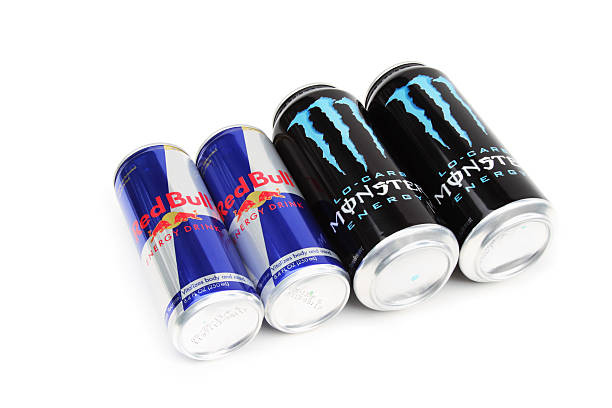 Red Bull and Monster Energy Drinks West Palm Beach, USA - November 28, 2011: A product shot of two well known brands of energy drinks: Red Bull and Monster. These energy drinks are caffeinated beverages supplemented with vitamins that purport to enhance performance and increase concentration. monster energy stock pictures, royalty-free photos & images