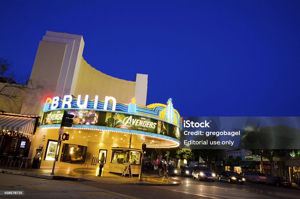 Bruin Theater at Westwood Village in Los Angeles, CA Los Angeles, United States - May 25, 2012: The historic Bruin Theater, located in the Westwood Village neighborhood of Los Angeles, is seen at night with people meandering around nearby. The theater is registered as a Los Angeles Historic-Cultural Monument and was constructed in 1937. The theater's marquee displays an advertisement for The Avengers. The Bruin Theater is also known as the Regency Bruin Theater. Movie Theater Stock Photo