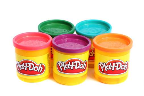 West Palm Beach, USA - November 26, 2011: This is a studio shot of five containers of various colored Play Doh modeling clays. Play Doh is manufactured by Hasbro.
