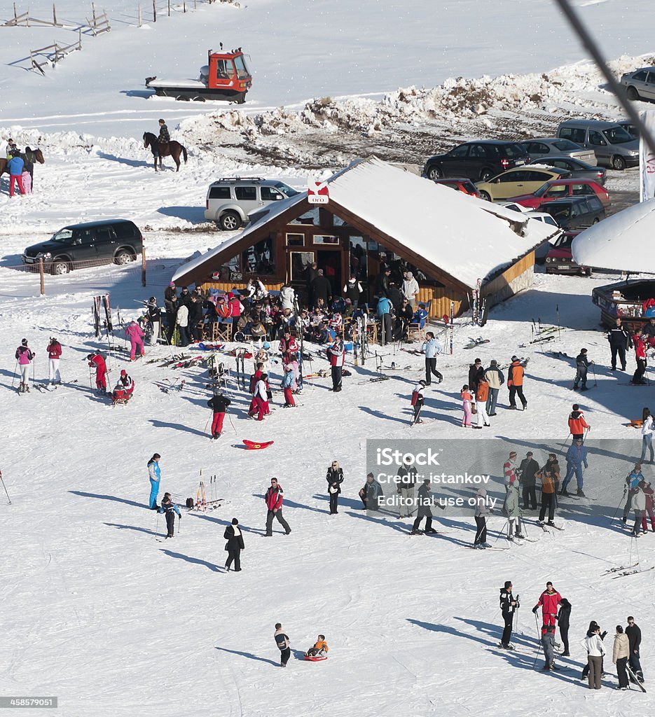 Skiing and enjoying the winter on mt Durmitor Aabljak, Montenegro - January 13, 2010: Ski course Savin Kuk on mt. Durmitor - Aabljak, - cafe bar "Oro". After chalenging downhil, lot of skiers enjoy beautiful sunny day with warm tea at front porch of Ski club "Oro" Ski Stock Photo