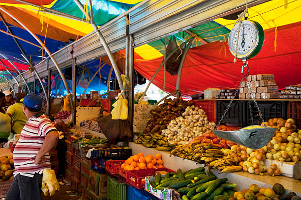 Willemstad, Curacao - March 7, 2011: The Floating Market, one of the most famous and picturesque sights in Punda, Willemstad. Venezuelan merchants sell fresh produce brought in on small fishing boats.