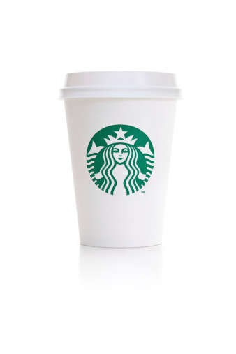 Ankara, Turkey - March 9, 2011 : A Starbucks paper cup with lid. Seattle based Starbucks operates a worldwide chain of over 15,000 coffee houses.