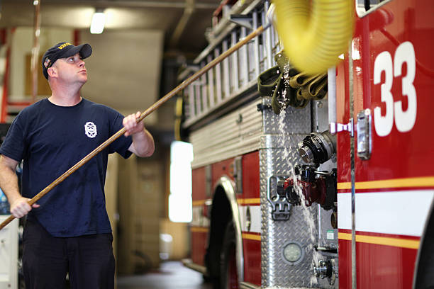 Man cleaning a fire-engine stock photo