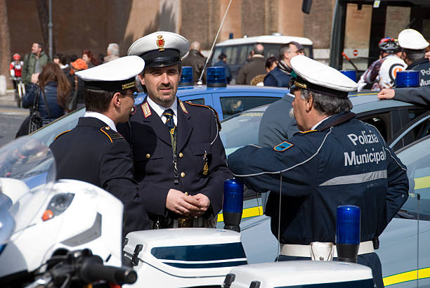 Rome, Italy - March 6th, 2011: Italian policemen at the Colosseum, watching and controlling the crowd there.
