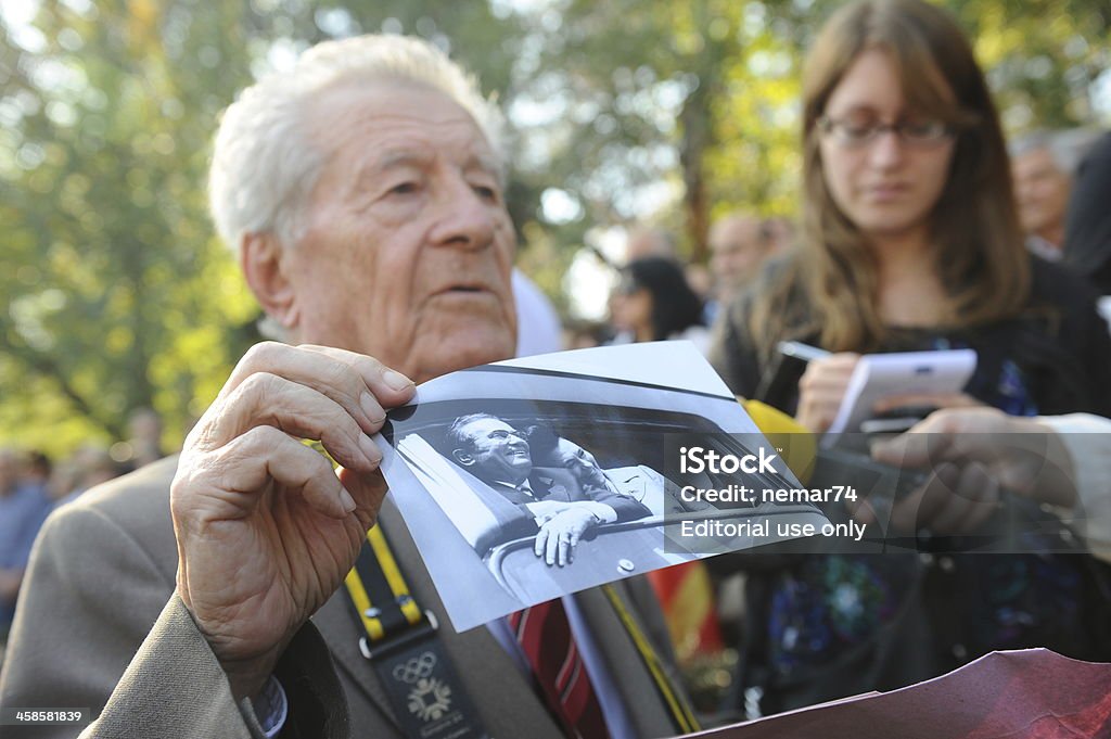 Jovanka Broz buried next to her husband Josip Tito Belgrade, Serbia - October 26, 2013: Photographer showing photos of Tito because he is one of the photographers who photographed Tito when he was alive.. Former Yugoslavia's first lady Jovanka Broz was laid to rest Saturday near the grave of her husband Josip Broz Tito in the House of Flowers mausoleum. several thousand people came to escort Jovanka to eternal life, as well as politicians from Serbia and around the world. Adult Stock Photo