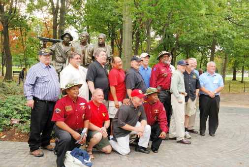 Washington, DC, USA - October 10, 2009: A group of Vietnam Veterans pose in front of the Three Soldiers Vietnam War Memorial Statue on the Mall in Washington DC.