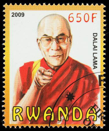 Sacramento, California, USA - January 8, 2011: A 2009 Rwanda postage stamp with an illustration of the 14th Dalai Lama pointing a finger straight ahead. Tenzin Gyatso was recognized as the 14th Dalai Lama in 1937, two years after his birth.