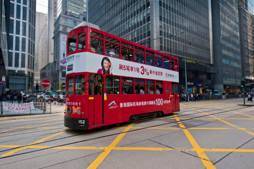 Hong Kong, China - January 23rd, 2011: Iconic red tram crossing road junction in Central District, Hong Kong Island.