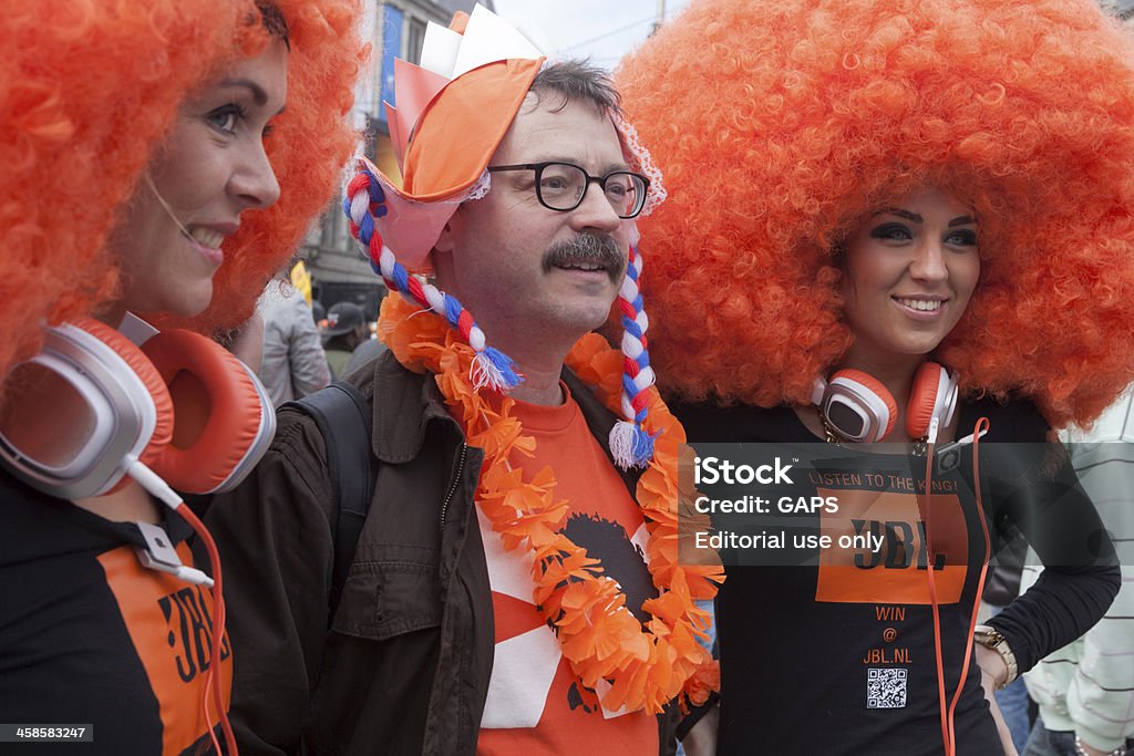 public celebrating the inauguration of King Willem-Alexander in Amsterdam Amsterdam, Netherlands - April 30, 2013: fans wearing the national coulor of orange celebrating in the streets of Amsterdam after the inauguration of King Willem-Alexander of the Netherlands and the abdication of his mother Princess Beatrix 2013 Stock Photo