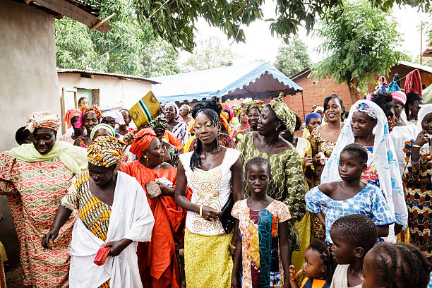 Traditional party Ziguinchor, Senegal - july 11, 2012: Women and children with elegant dresses, celebrate with all your neighbors the baptism of the small one of the family senegal photos stock pictures, royalty-free photos & images