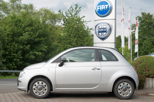 Luetzelbach, Germany- June 10, 2012: Side view of a new Fiat 500 outside a car dealership. Fiat 500 is a a compact car the first series were produced in 1957. Fiat S.p.A. is an Italian automobile manufacturer, engine manufacturer, financial and industrial group based in Turin in the Piedmont region.