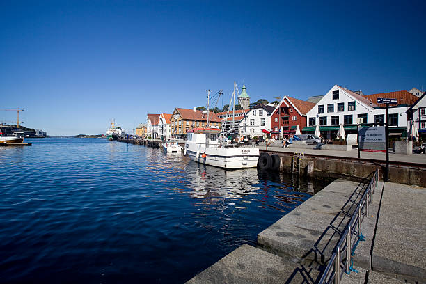 Stavanger, Norway - September 3, 2010: A view of the town centre harbour area with classic wooden house architecture and historic firewatch tower.
