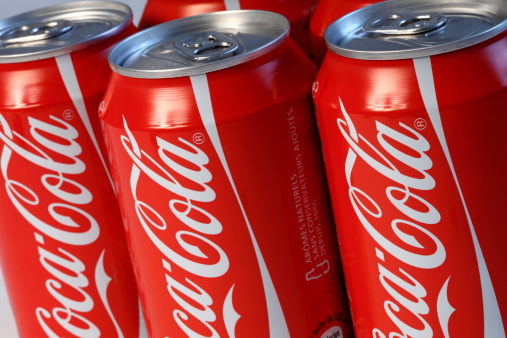 Paris, France - July, 20 2011 : Iconic red coca cola carbonated drinks cans photographed in a studio. Coca-Cola is produced by The Coca-Cola Company of Atlanta, Georgia.