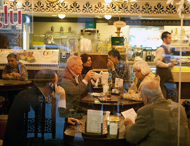 Istanbul, Turkey - November 5th, 2009 : People enjoying desserts from Gulluoglu - one of the oldest and best known dessert shops in Karakoy, Istanbul. Desserts along with many cups of hot Turkish tea is a favourite combination among the locals.