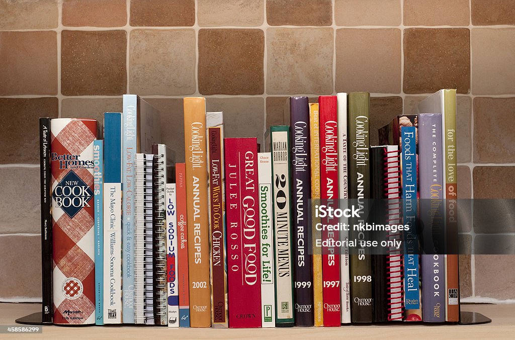 Cookbooks on kitchen shelf London, England-April 2, 2011.  Cookbooks on kitchen shelf.  Cook books include one by Julee Russo a Better Homes Cook book and many cookbooks published by Cooking Light. Cookbook Stock Photo