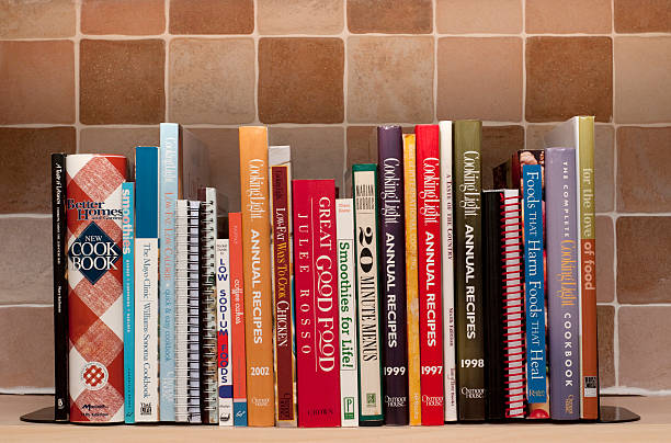 Cookbooks on kitchen shelf stock photo