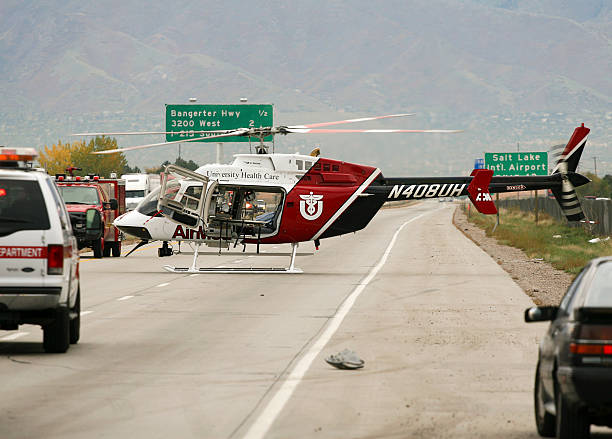 Salt Lake City, Utah, USA - October 14, 2006: A Bell 407 helicopter from University of Utah Health Care AirMed sits on the Utah State Route 201 roadway waiting to transport injured victims at the scene of a car accident.