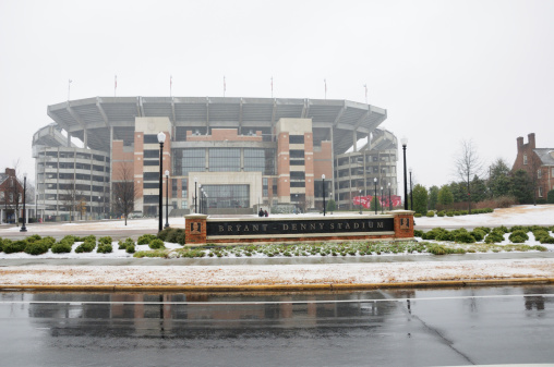 Tuscaloosa, Alabama, USA - January 10, 2011: Bryant-Denny Stadium and sign located on The University of Alabama campus in Tuscaloosa, Alabama (USA). Photo taken right after a light snowfall that closed the campus. View from University Drive on the north side of the stadium.