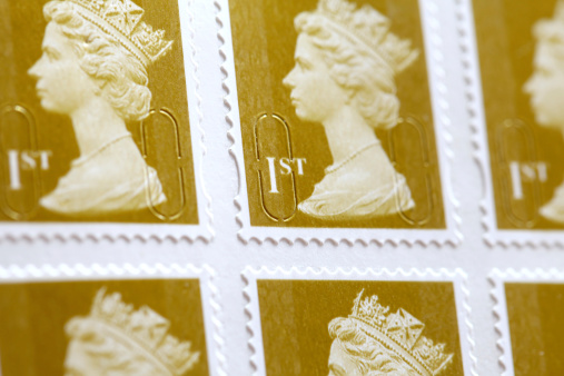 London, United Kingdom - April 24, 2012: British First Class Stamps. The first stamp issued in the UK was the Penny Black in 1840
