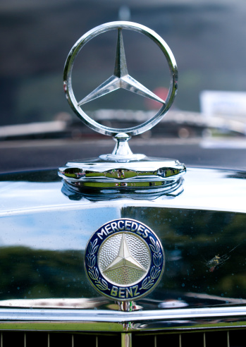Copenhagen, Denmark - August 6th, 2011: Original Mercedes Benz ornament in silver mounted on the hood of a car. The silver star has been the trademark of Mercedes Benz since 1909