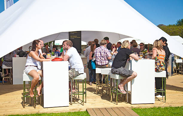 Edinburgh, Scotland, UK - 3rd July, 2011: People relaxing, chatting and sampling food and drink from the chefs and exhibitors at the Taste of Edinburgh food festival in The Meadows.
