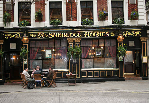 London, England - April 1, 2016: Crowds gather outside the home of fictional detective Sherlock Holmes - 221b Baker Street, London.