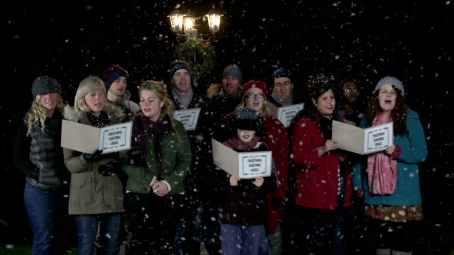 Group of Christmas Carol Singers, singing in the snow