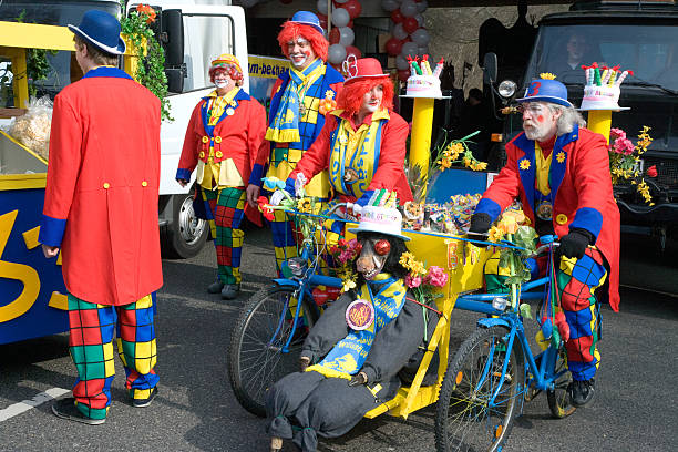 Cologne, Germany - March 5, 2011 : Five colorful clowns at carnival parade in Cologne, two of them driving a self constructed bike just for fun.