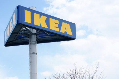 Graz, Austria - March 26, 2011: Large IKEA logo on pole in Graz. Clouded sky in background. Tree is partly visible in lower part of image. IKEA is producer of low price furniture located south of Stockholm in Sweden with branches all over the world.