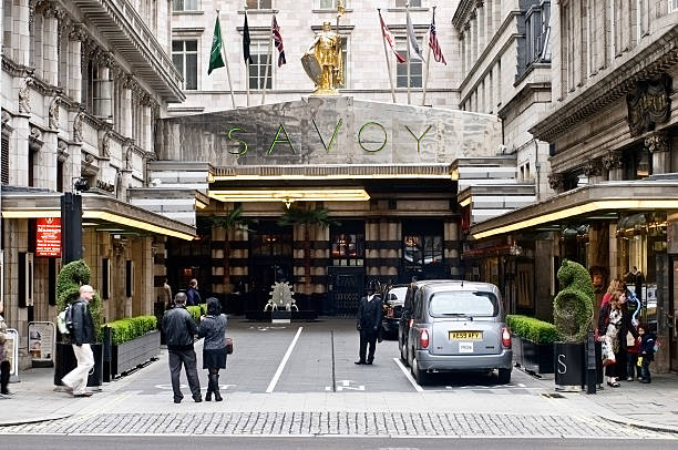 London, UK - April 5, 2011: SAVOY Hotel in London. Image of the main entrance of the Savoy Hotel in London. It is situated on the Strand, Central London.Shot in late afternoon from across the road. It was established on 6th august 1889.
