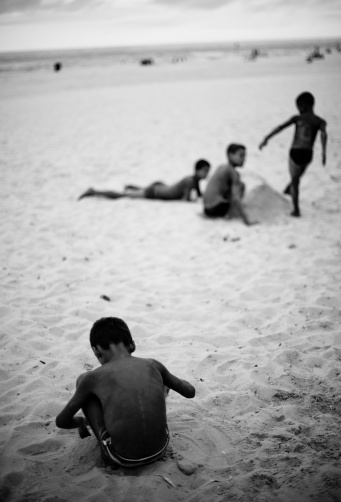 Rio de Janeiro, Brazil - March 7, 2011: A group of Brazilian kids play on the beach during the annual Carnival celebration. This was taken on Ipanema beach.