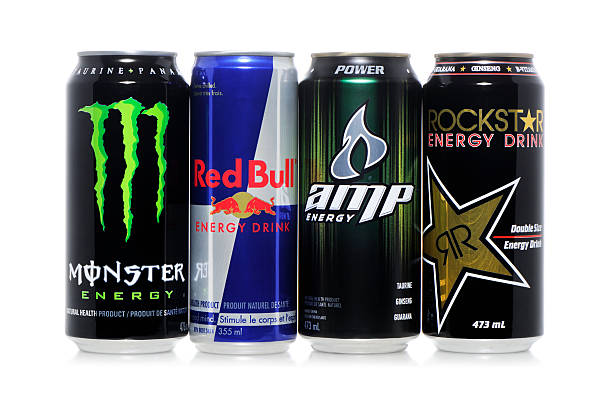 Energy drinks Beloeil, Canada-March 31, 2011: Monster, Red Bull, Amp and Rockstar energy drinks in tall cans isolated on white. monster energy stock pictures, royalty-free photos & images