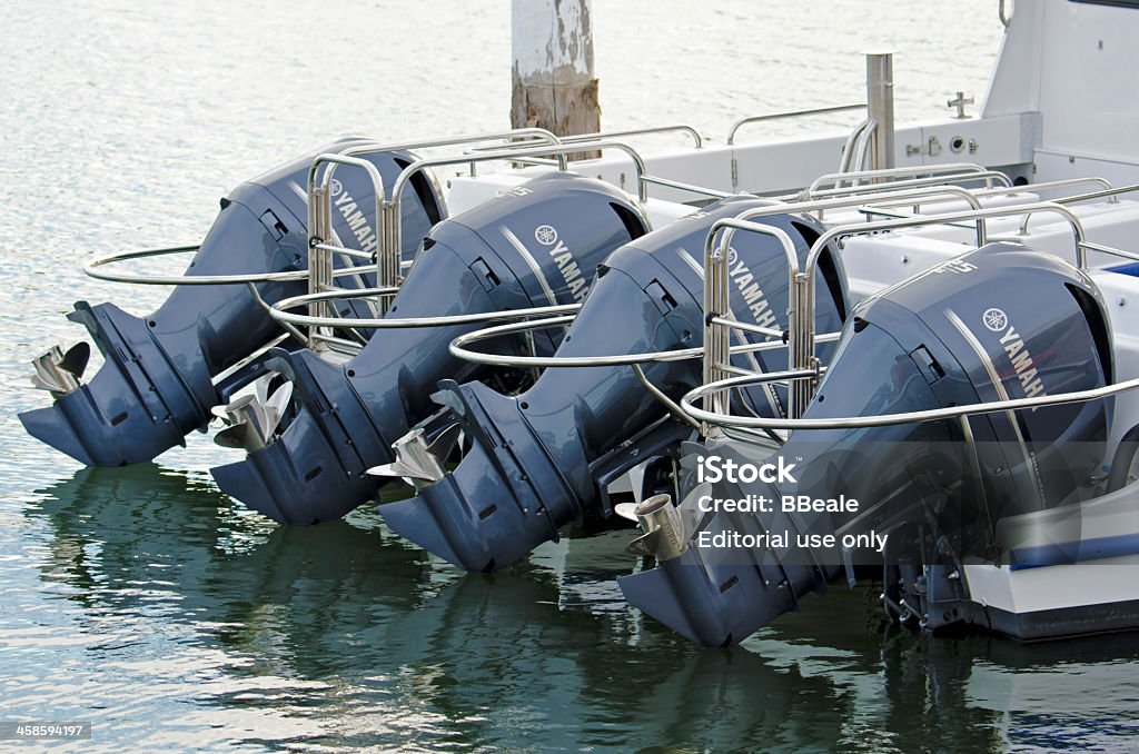 Outboard motors Newcastle, Australia - October 5, 2013: Two Water Police boats berthed side by side, with their powerful outboard motors lined up. Outboard Motor Stock Photo