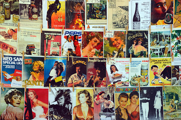 Athens, Greece - February 7, 2011: Vintage advertisements and magazine covers, hanging outdoors for sale at Athens Flea Market in Plaka.