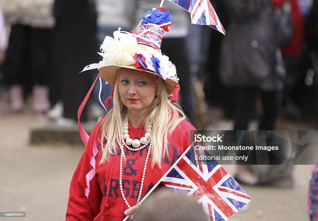 Royal Wedding in London, England London, England - April 29, 2011: An unidentified royal supporter arrives on The Mall near Buckingham Palace to await the arrival of Prince William after his marriage. Flag Stock Photo
