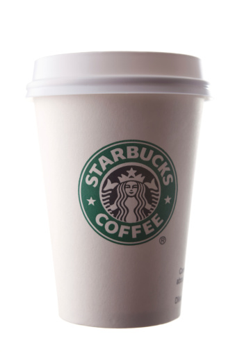 Antalya, Turkey - July 18, 2011: A Starbucks coffee cup with its official green logo on white background. Starbucks is a very popular global Coffeehouse franchise born in USA and serve in large parts of the world.