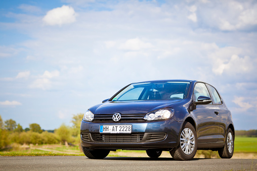 Dannenberg, Germany - May 1, 2010: Dark Blue Volkswagen Golf (Golf Mk6-series) on a dike along the Elbe near Dannenberg on the Elbe (Germany). The Volkswagen Golf Mk6 (or VW Typ 5K) is the successor to the Mk5, and was unveiled at the Paris Auto Show in October 2008. The Volkswagen Golf is a small family car manufactured by Volkswagen since 1974 and marketed worldwide across six generations, in various body configurations and under various nameplates – as the Volkswagen Rabbit in the United States and Canada (Mk1 and Mk5), and as the Volkswagen Caribe in Mexico (Mk1).