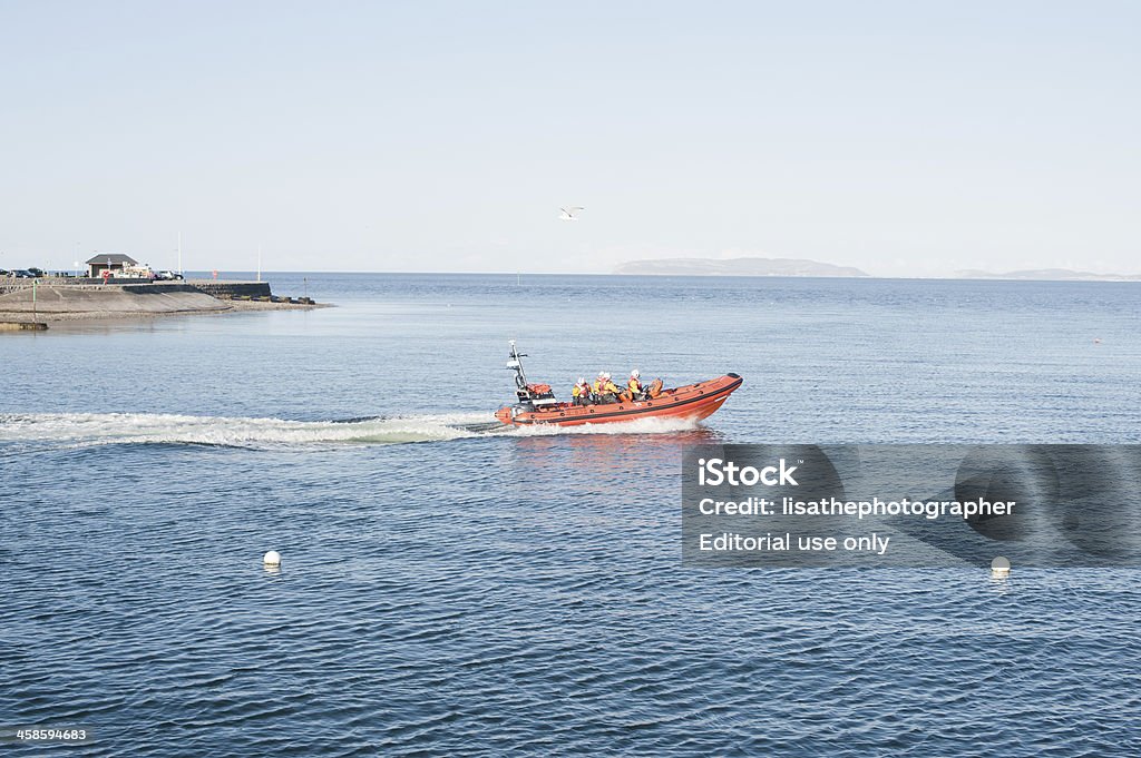 RNLI Lifeboat Launch Beaumaris, Wales - April 12, 2012: An RNLI rescue lifeboat being launched in the small port of Beaumaris, Wales in the UK to an emergency call. Beach Stock Photo