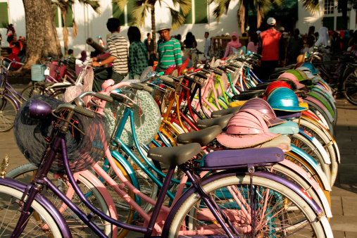 Jakarta, Java, Indonesia - July 6, 2011: a row of colourful bikes for rent in Kota, the old colonial Dutch Quarter in Jakarta (Java, Indonesia).