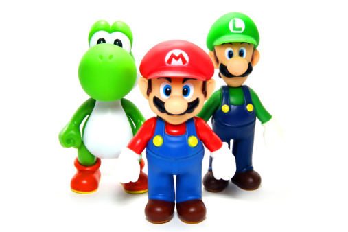 Vancouver, Canada - April 9, 2012: Mario, Luigi and Yoshi from the Nintendo Super Mario franchise of games, posed against a white background. The toys are from Banpresto Company.