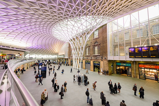London, UK - May 2, 2012: People in the departure concourse of King's Cross Station.  The station serves as an important national railway terminus, and as part of the London Underground network.  The redesigned concourse was opened in March 2012.