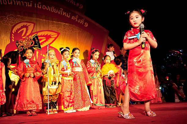 Chinese New Year Pagent Chiang Mai, Thailand - February 4, 2011: Young girls take part in a pagent at Chinese new year celebrations in Chiang Mai, Thailand. The festivities are cetnered around the Warorot market and attrat many foriiegn tourists. warorot stock pictures, royalty-free photos & images