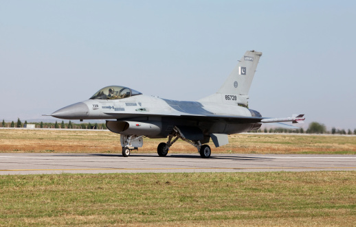 Beja, Portugal: parked General Dynamics F-16 Fighting Falcons of the Portuguese Air Force - in the foreground a twin-seat F-16 BM version, the rest are F16 AMs - equipped with external fuel tanks - Beja Airport serves both civil and military aviation.