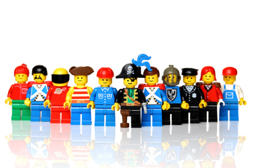 London, United Kingdom - July 18, 2011: A group of lego mini figures  on white background. The lego figure is a small plastic toy available through the Danish toy manufacturer the Lego Group. They were first produced in 1978