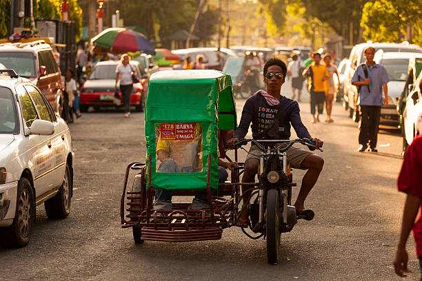 Motorcycle running on the road through a Large Advertisement