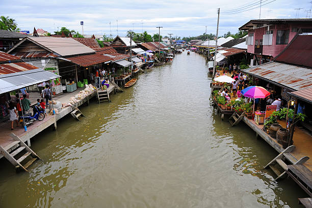 Floating market Samudsongkarm, Thailand - September 26, 2009: Tourist sightseeing at Amphawa floating market at Samudsongkarm, Thailand. mode of transport rowing rural scene retail stock pictures, royalty-free photos & images