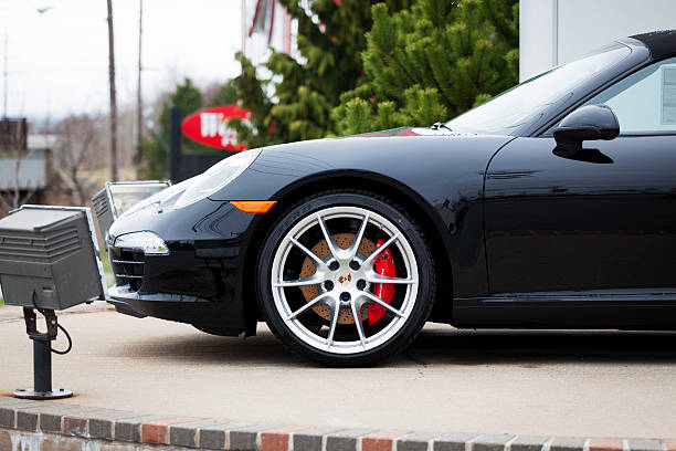 Halifax, Nova Scotia, Canada - April 22, 2012: Porsche 911 Carrera S Cabriolet 991 Series on display at a Porsche dealership in Halifax, Nova Scotia.  Lights for night time display surround the vehicle.  The 991 Carrera S Cabriolet features a 3.8-liter, 400 hp engine and is the first to use mostly aluminum construction.  It is only the third entirely new platform for the 911 since it's introduction in 1963.