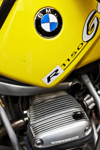 Rome, Italy - October 26, 2011: BMW Logo on a yellow R 1150 Motorbike.  BMW is a German automobile, motorcycle and engine manufacturing company founded in 1916.