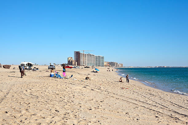 Puerto Penasco, Mexico - November 26, 2011: People on Sandy Beach in Puerto Penasco, Mexico also known as Rocky Point. Many new hotels are going up on this beach and tourism is increasing in this area.
